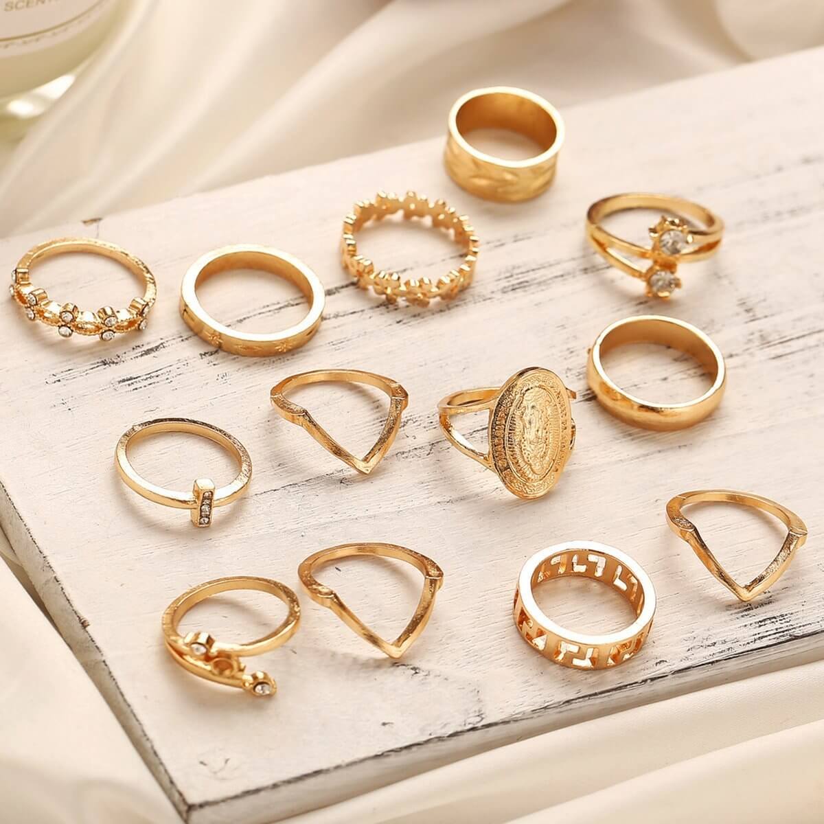 The 13-Piece Medallion Ring Set combines elegance and versatility with its intricate designs and shimmering Austrian crystals. Each ring is 18K gold-plated, ensuring a luxurious finish and long-lasting brilliance.