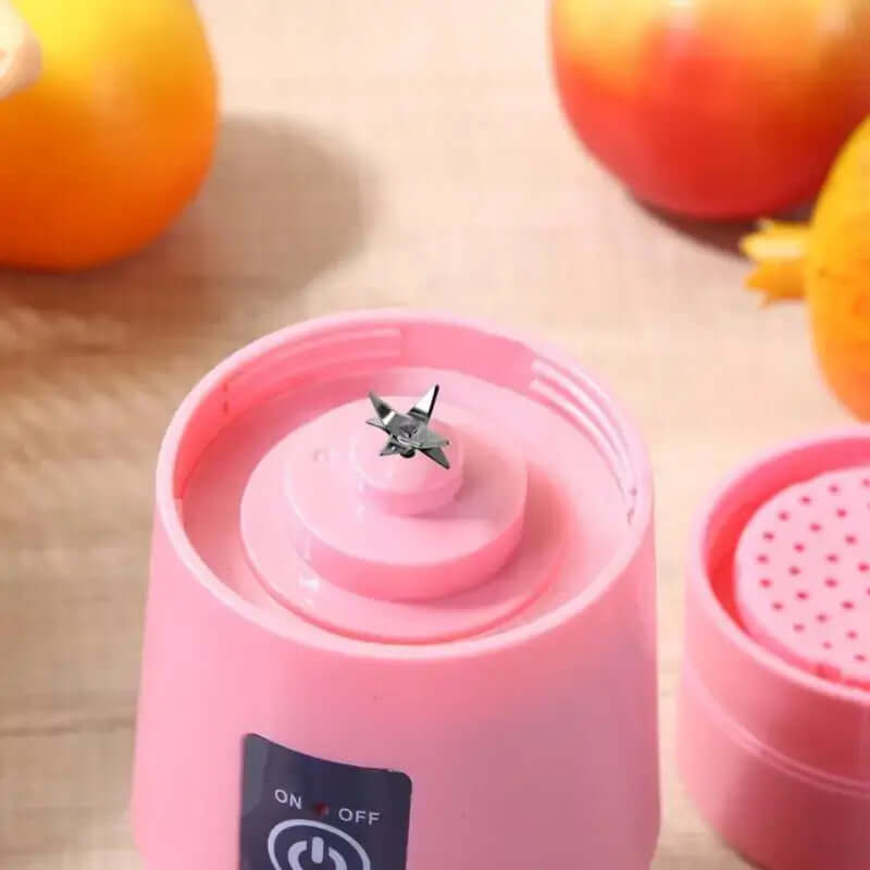 Close-up of portable juicer cup blender with sharp metal blades, ideal for making vegetable and fruit smoothies on-the-go.